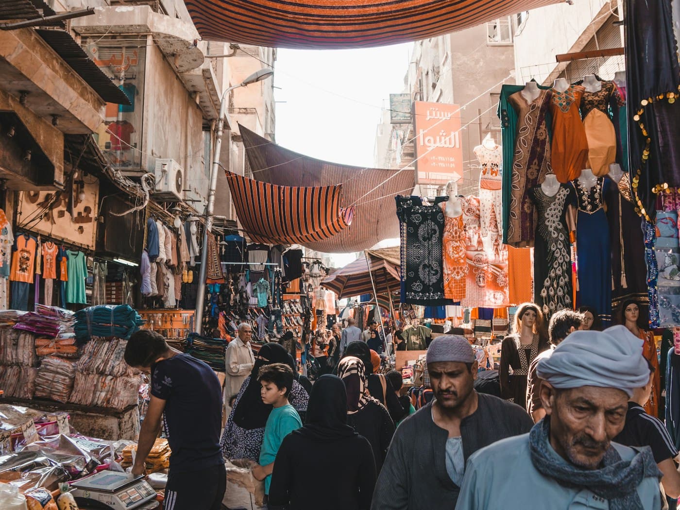 Shoppers walking through the lantern lit lanes of Khan el Khalili in Cairo